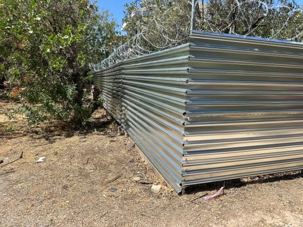 Λεπτομέρεια περίφραξης με γαλβανιζέ λαμαρίνα και ανθεκτικούς ορθοστάτες